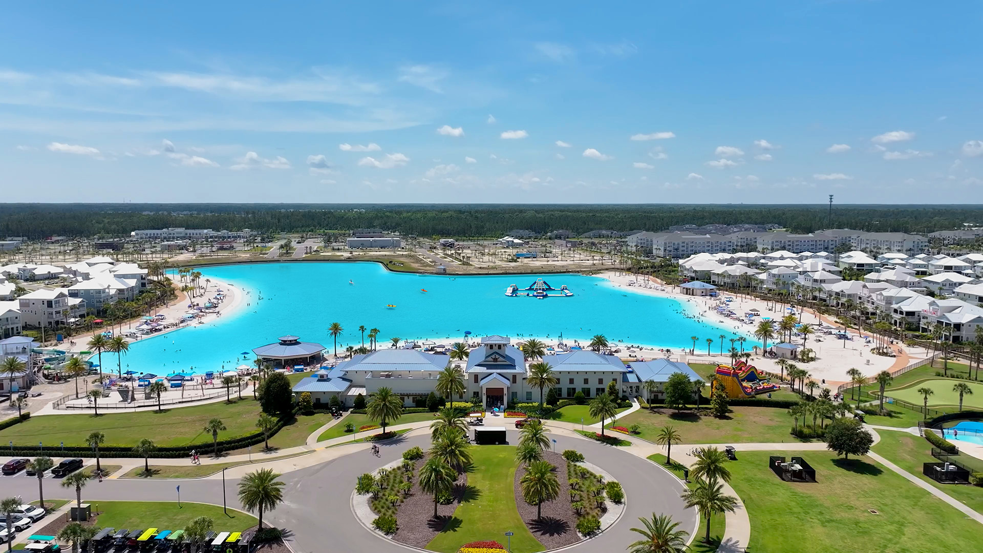 Aerial view of the Beachwalk lagoon shoreline with white-sand beaches, beach club and residential community, Crystal Lagoons lagoon in St. Johns County, Florida